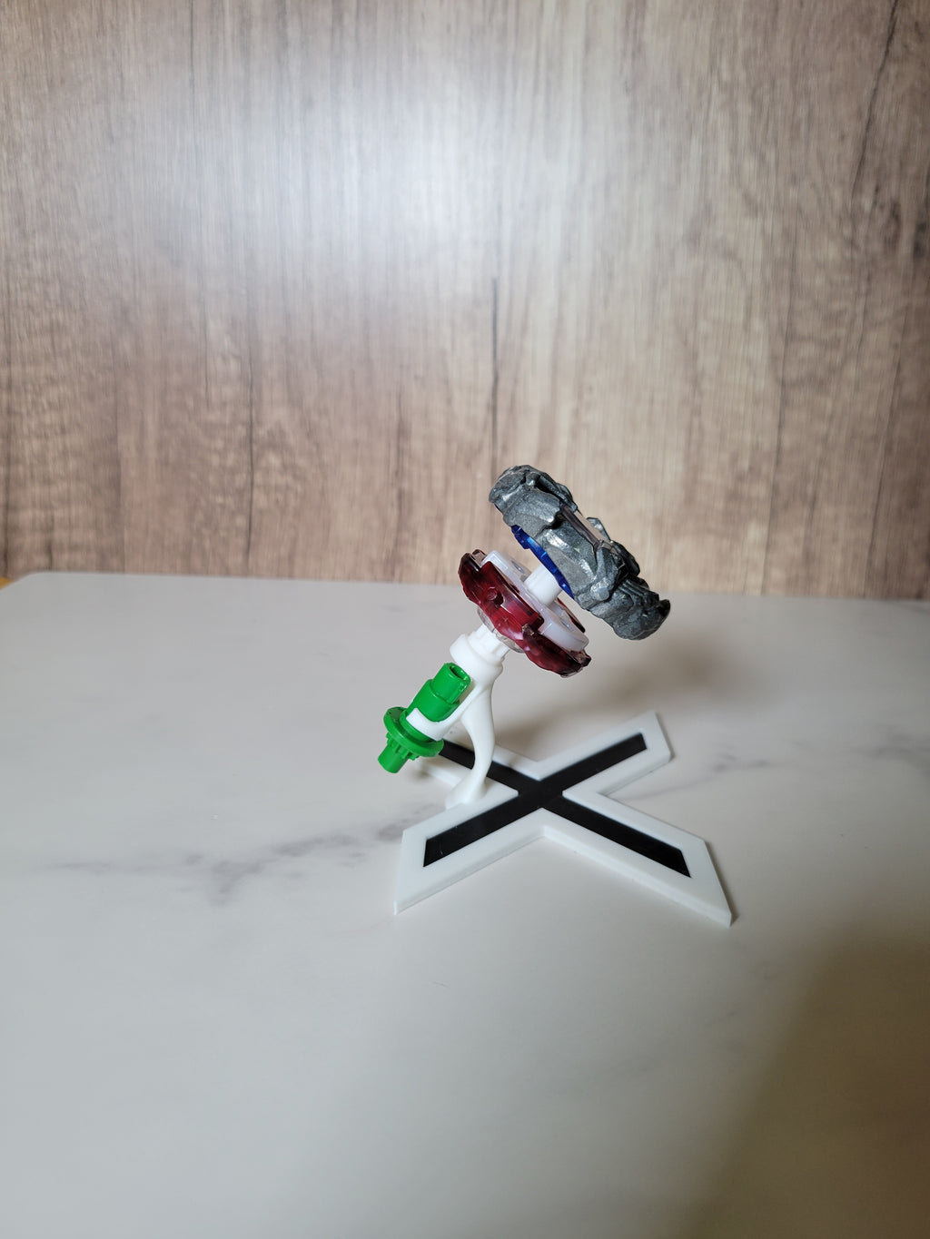 Side view showing the separate blade, ratchet and bit display positions on the X-shaped stand.