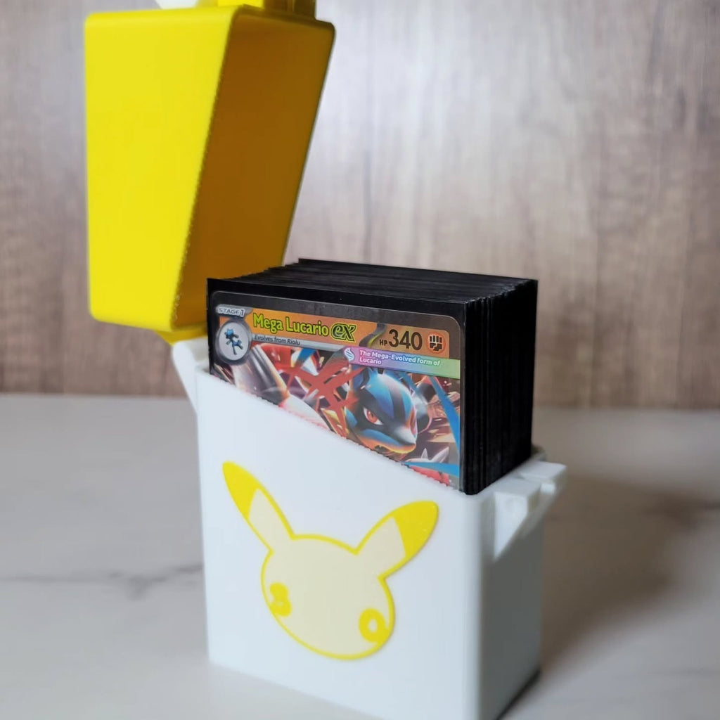 White-and-yellow anniversary-inspired deck box opened to show a sleeved trading-card deck.