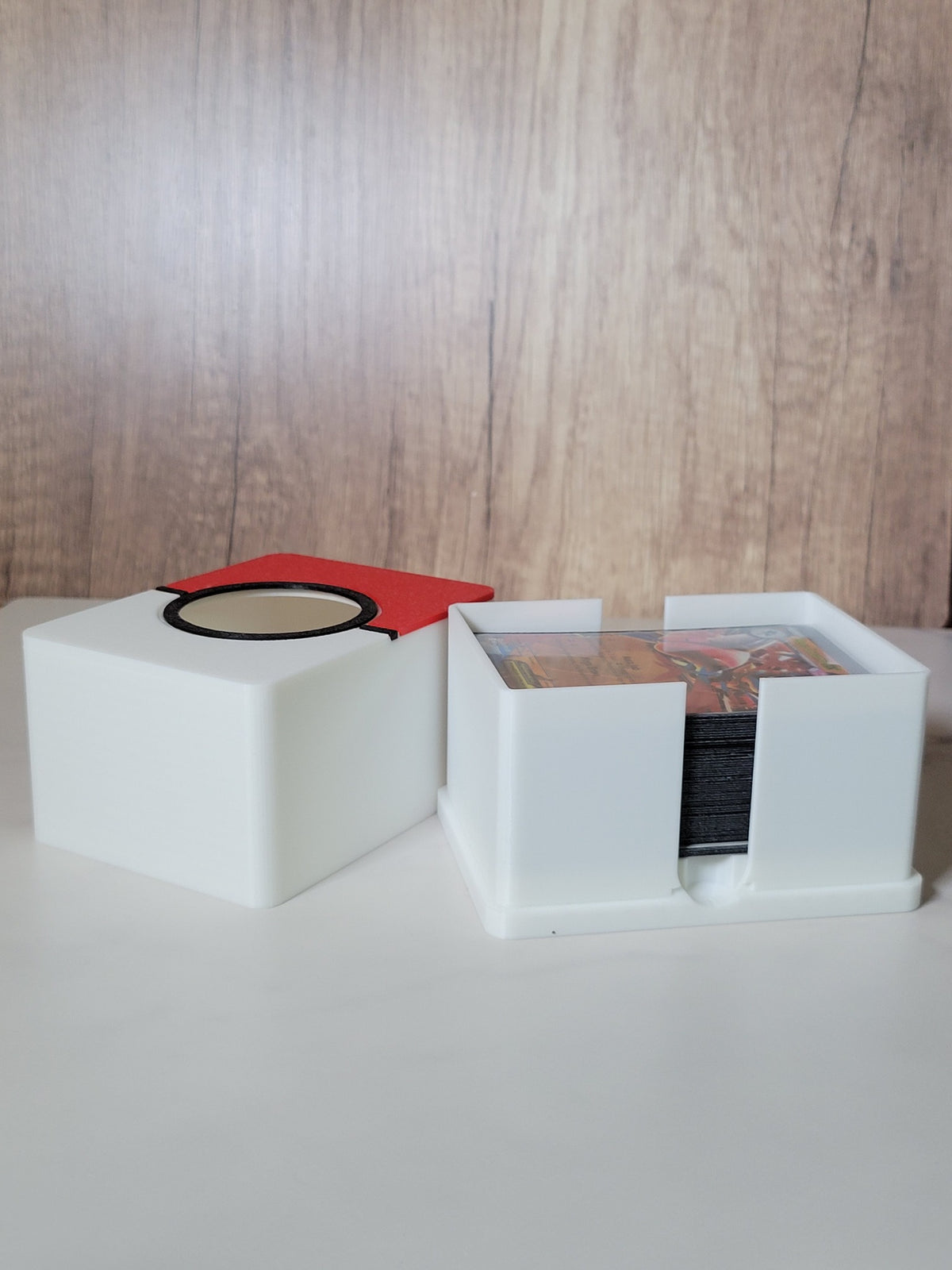 Open deck box beside its lid, showing a tested 60-card sleeved deck with space remaining.