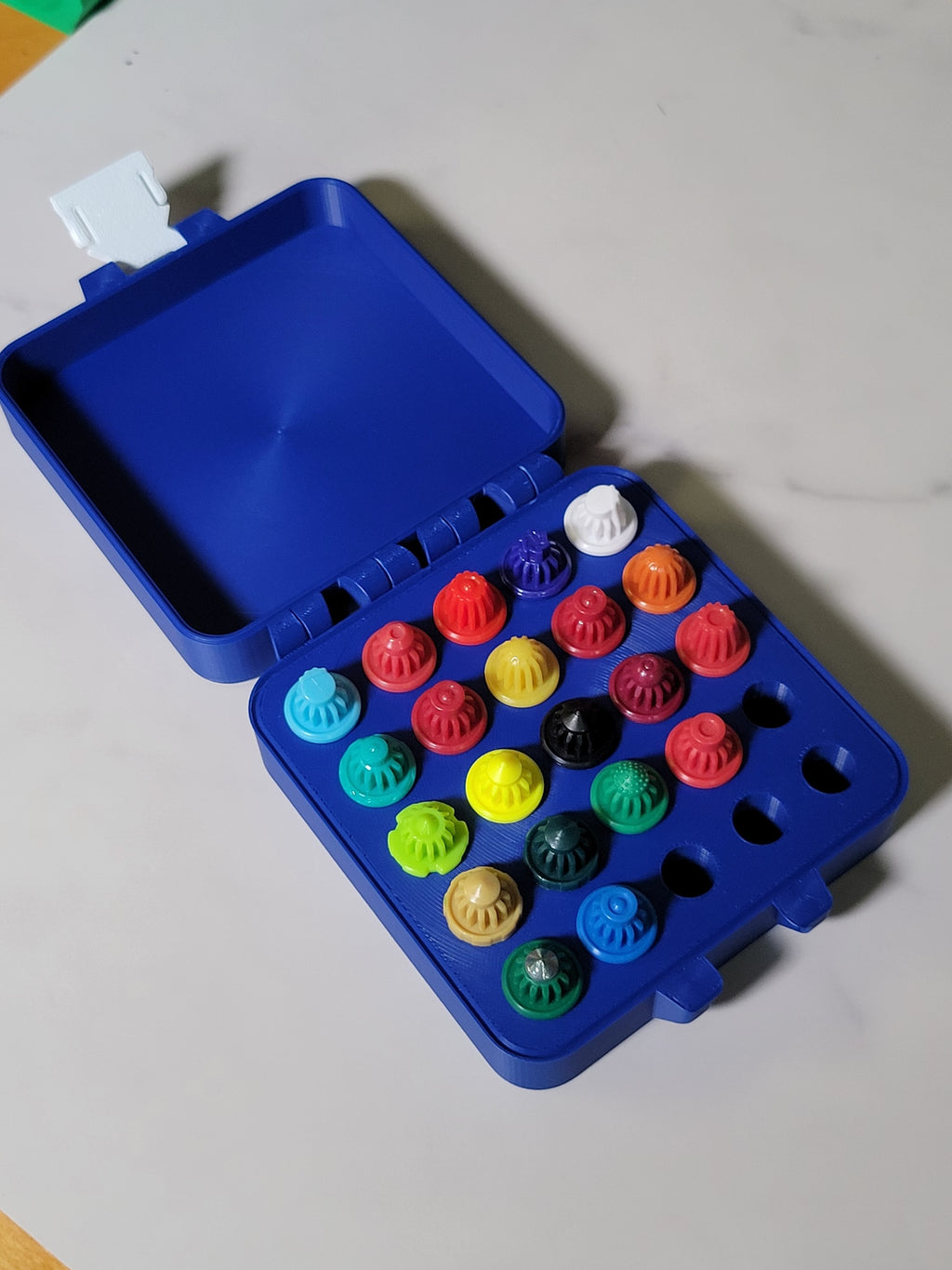 Open 25-slot Bit Box containing colorful Beyblade X bits.