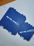 Blue and white 64-slot and 25-slot Beyblade X Bit Boxes shown side by side.