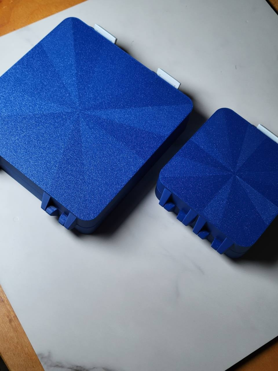 Underside comparison of the large and original blue Bit Boxes.