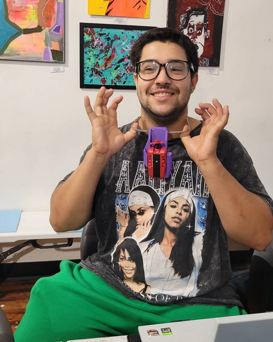 Tournament attendee showing a purple Ruzz3D launcher holster attached to a chain.