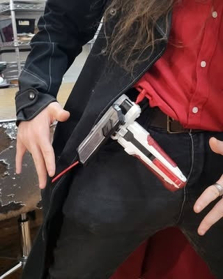 Tournament player wearing Beyblade accessories on a belt setup.
