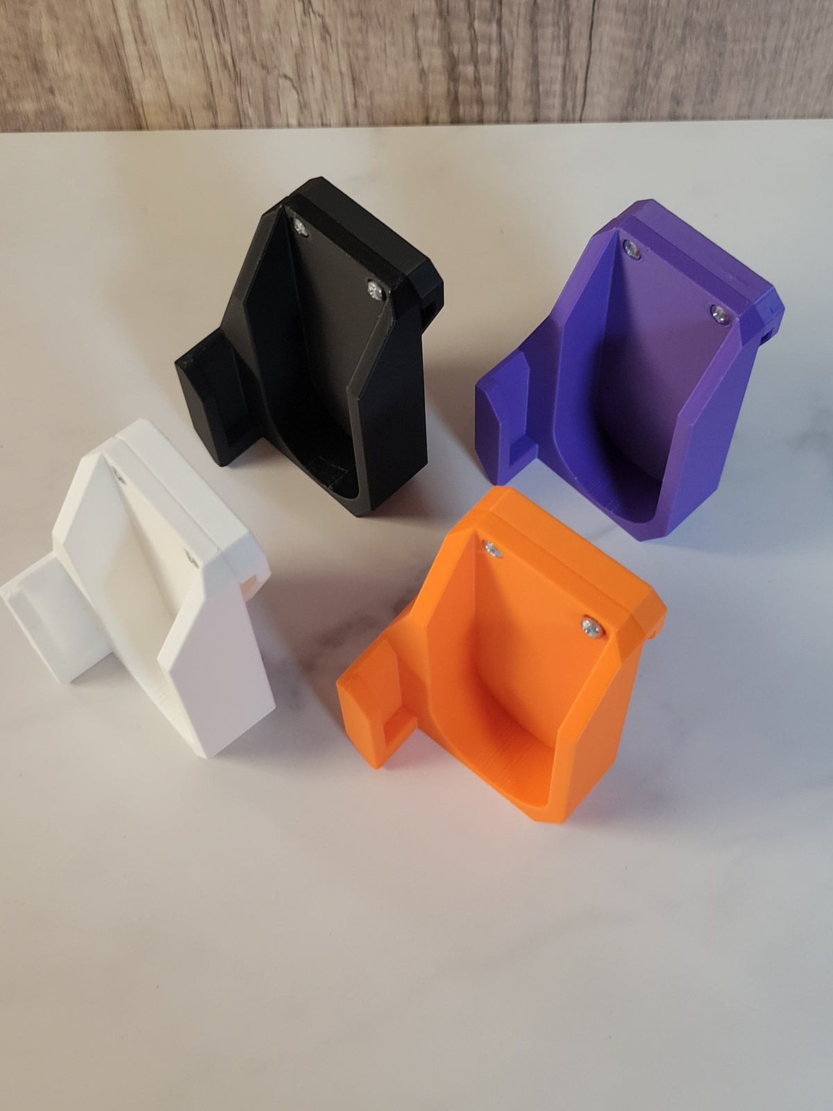 Black, purple, white and orange launcher holsters arranged together.