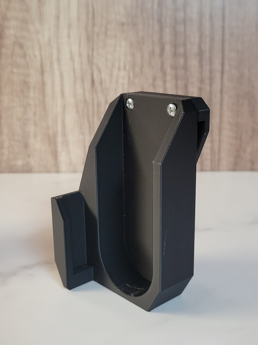 Side profile of a black printed launcher holster.