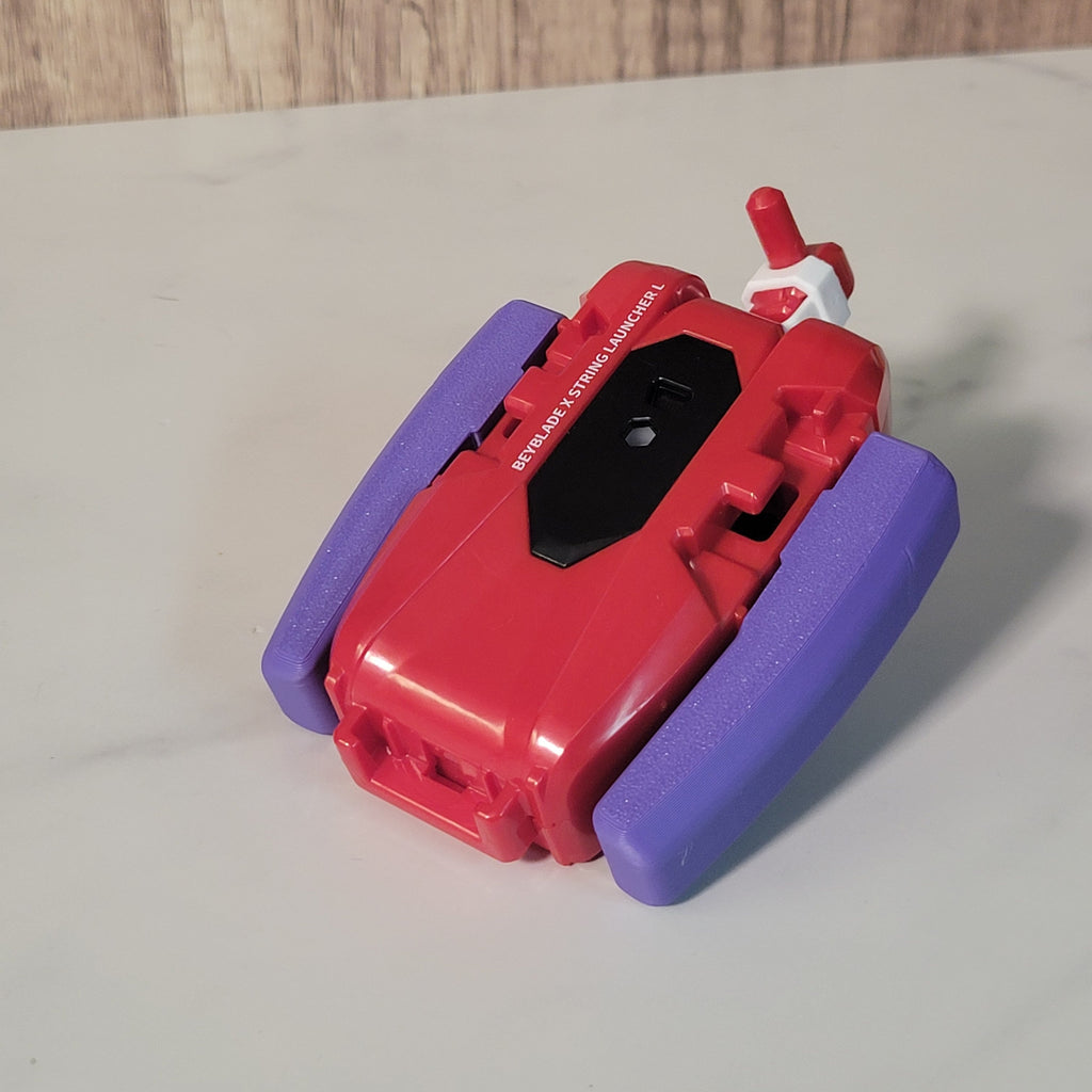 Front view of a red launcher with the purple printed grip attached.