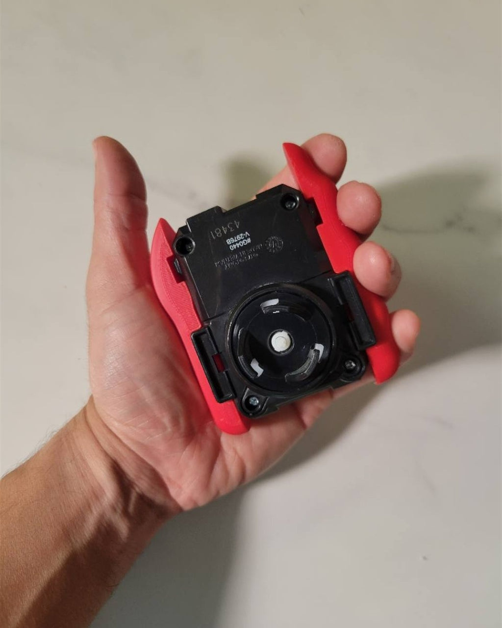 Rear view of the launcher grip held in a hand.