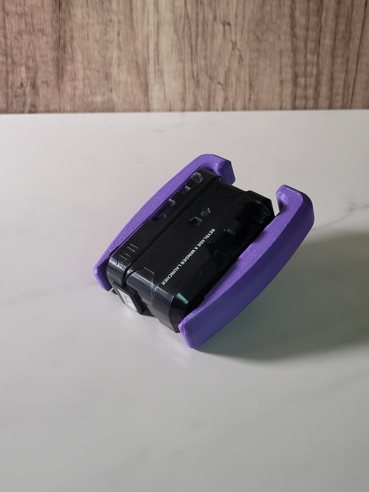 Purple winder launcher grip shown around its launcher.