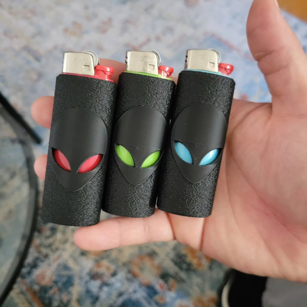 Three dark lighter covers with red, green and blue alien-eye accents.