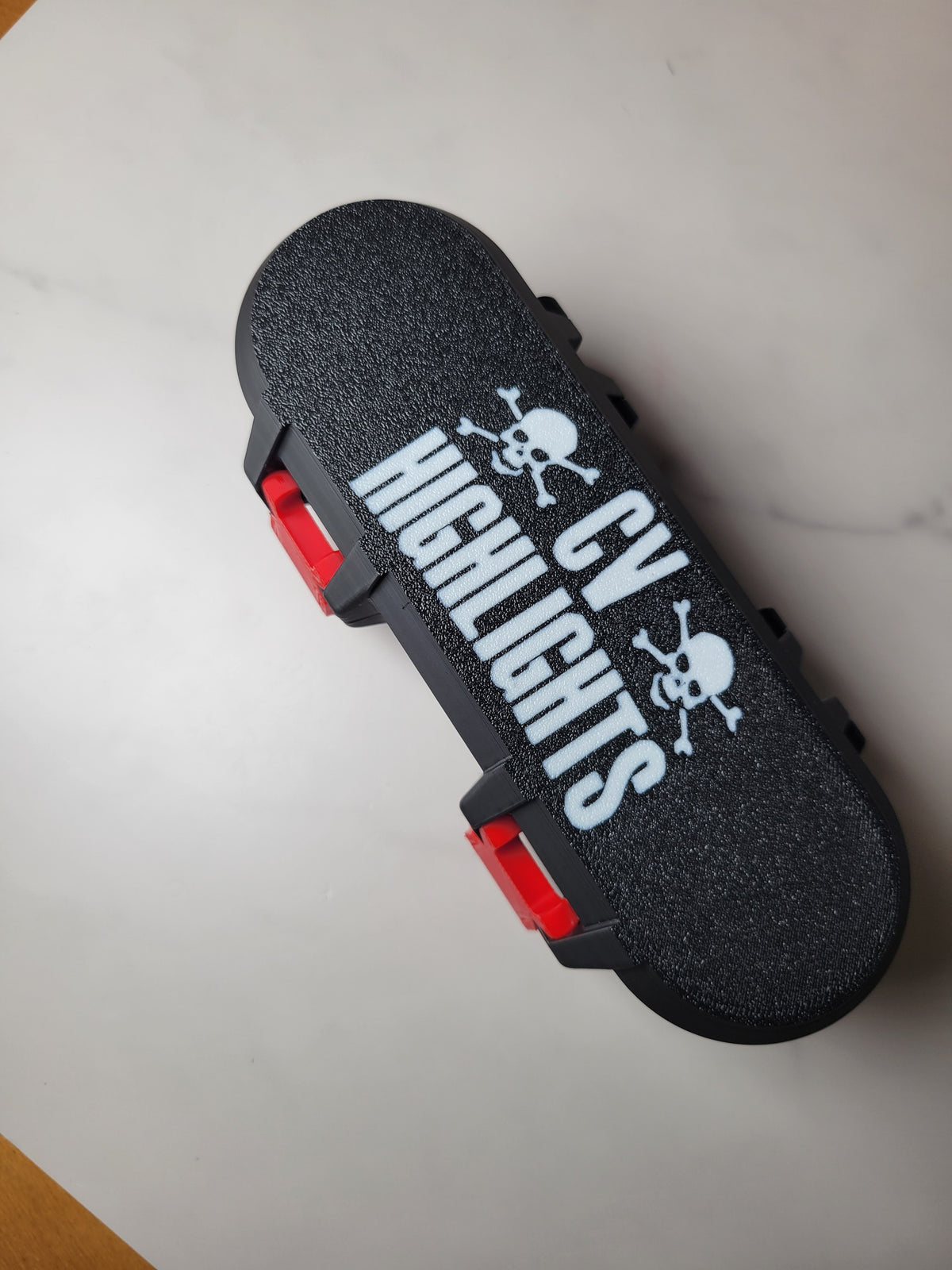 Black personalized Beyblade deck box with white lettering and red clips