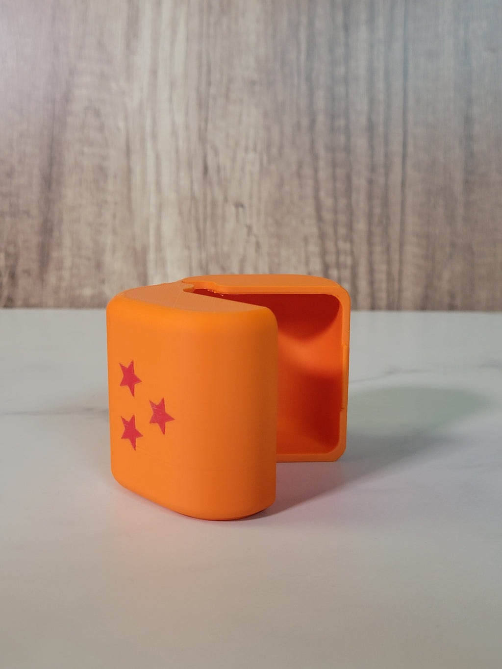 Dragon Ball-inspired orange deck box detail.