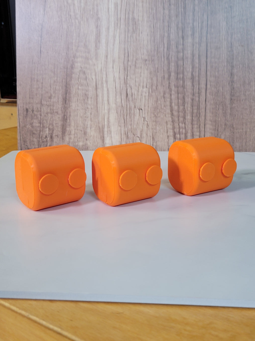 Rear view of three orange printed belt deck boxes.