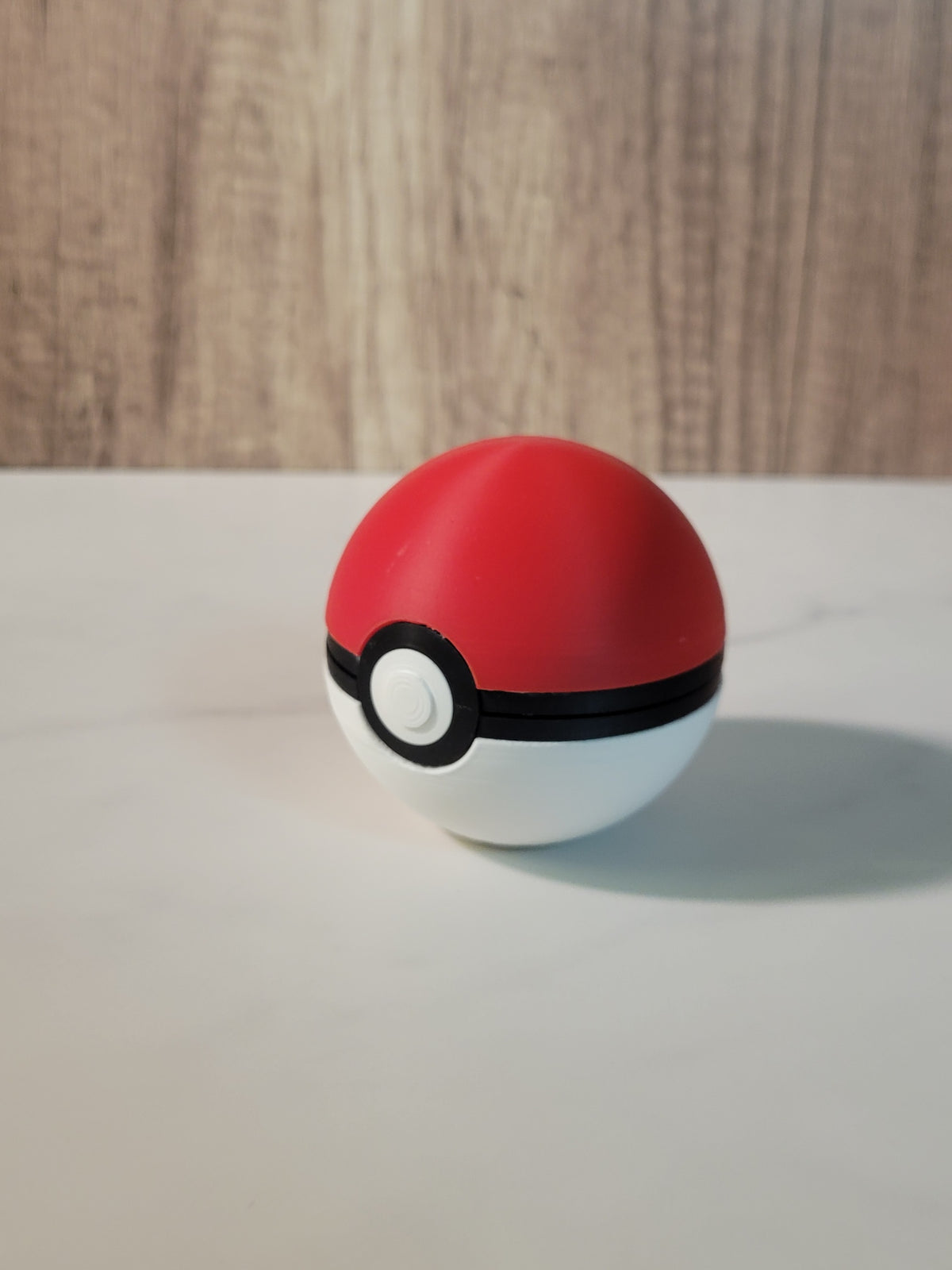 Closed red and white Poke Ball inspired clamshell holder