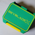 Green Ratchet Box with yellow Beyblade X-inspired lid detail.