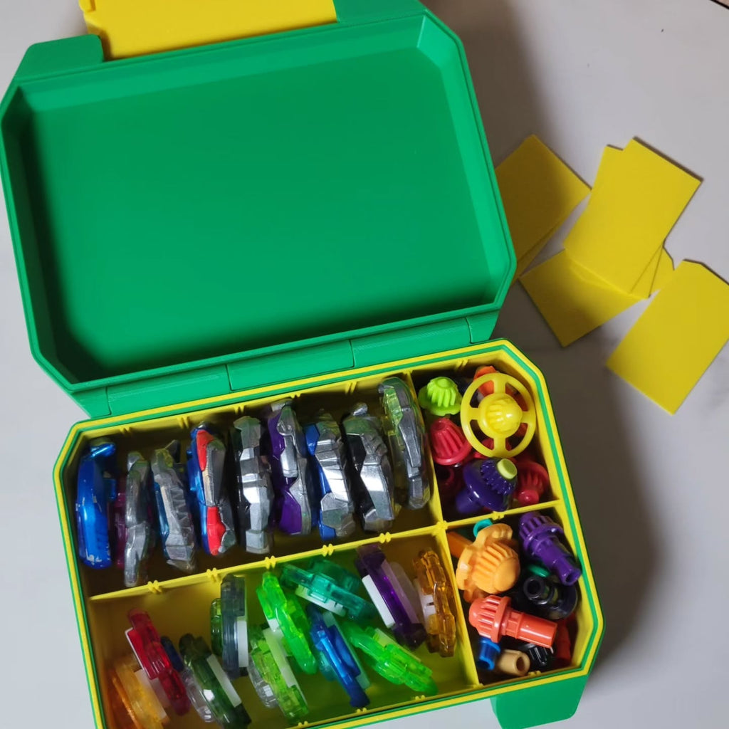 Open green and yellow Ratchet Box containing Beyblade accessories and a smaller Bit Box.