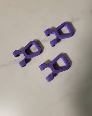 Purple small pull grips laid flat to show finger openings and cord attachment details