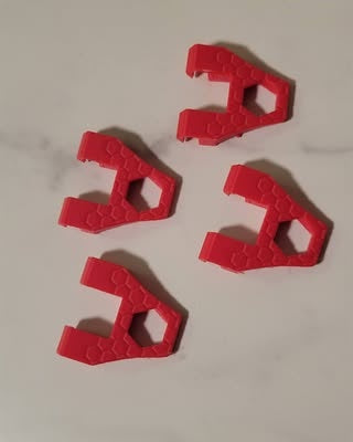 Red 3D-printed pull grip examples with finger openings; one grip per order