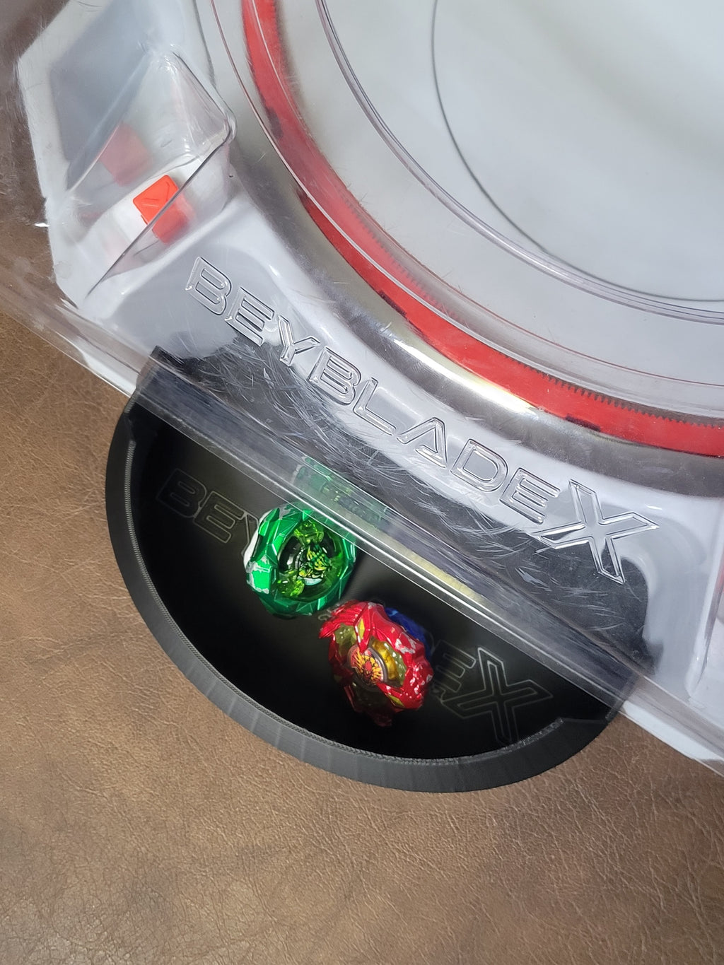 Black Xtreme Pocket catch tray attached at a Beyblade X stadium opening.